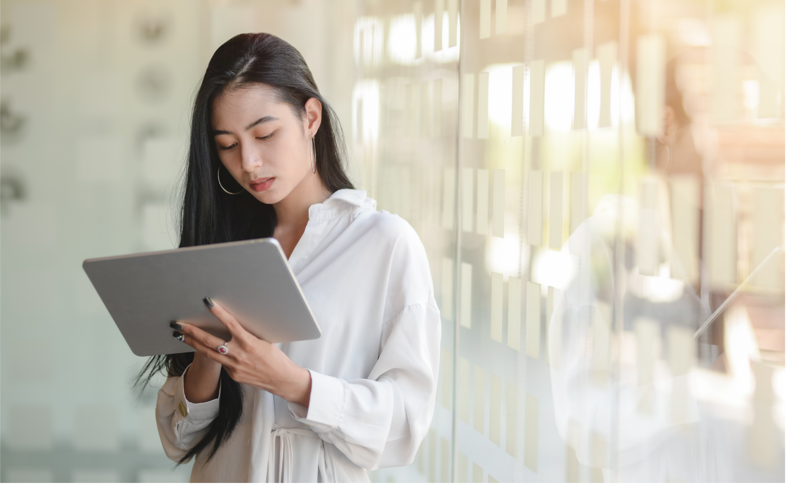 Small business owner using a tablet for salon management and online appointments